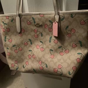 Coach city tote signature canvas with heart cherry print will stand out.